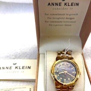 Anne Klein solar powered "Consider It" wristwatch in polished gold tone NWT